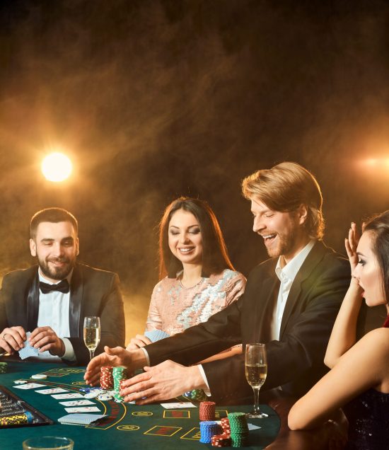 upper class friends gambling in a casino.