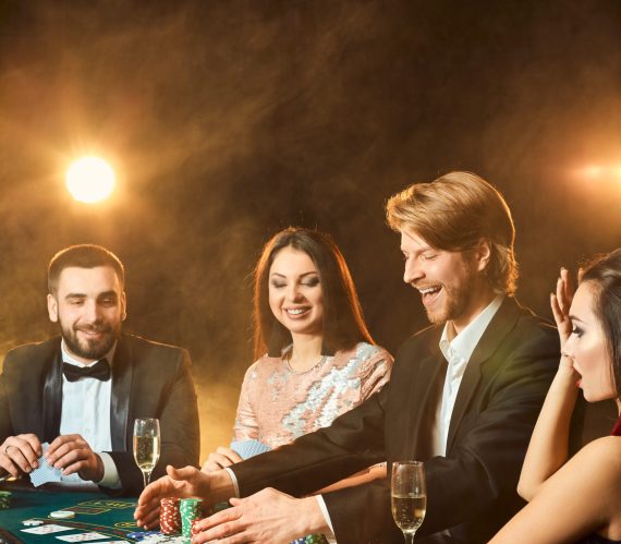 upper class friends gambling in a casino.